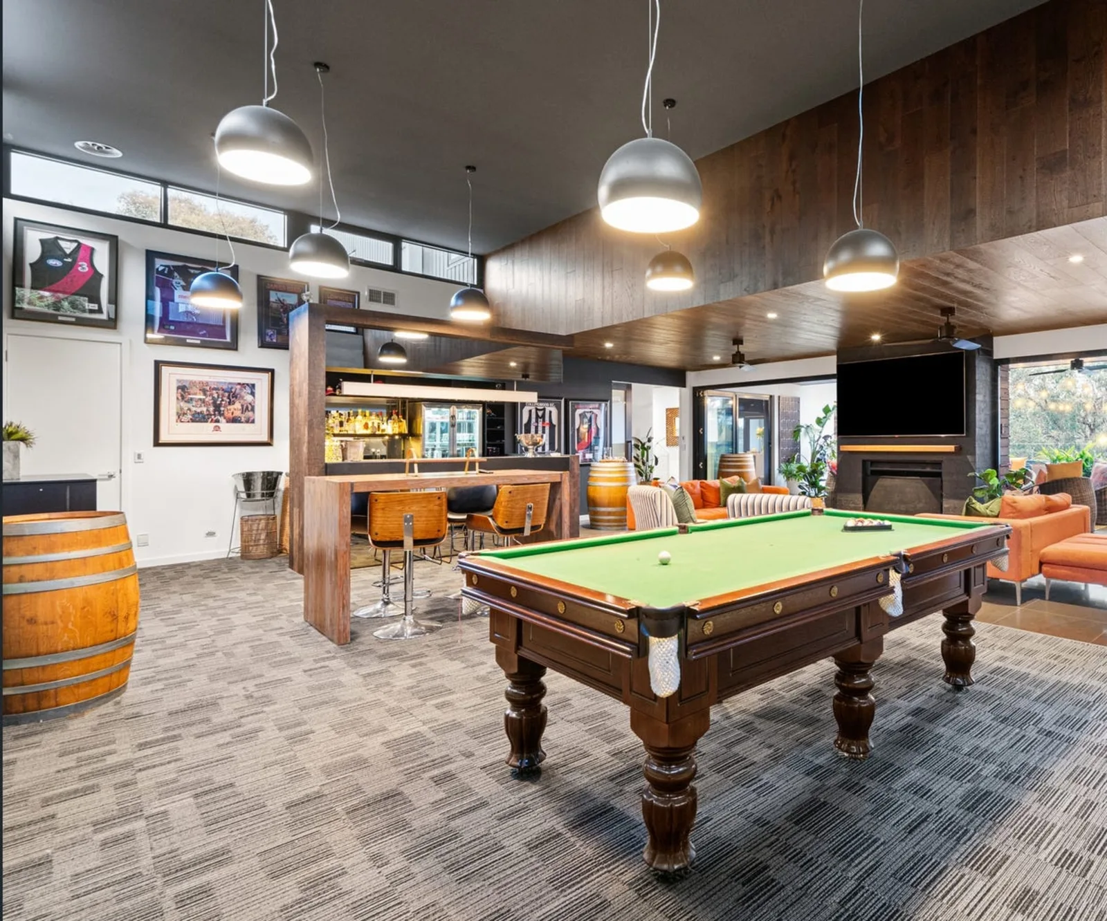 Games room with feature pendant lighting, AV and bar - Yarrambat, VIC